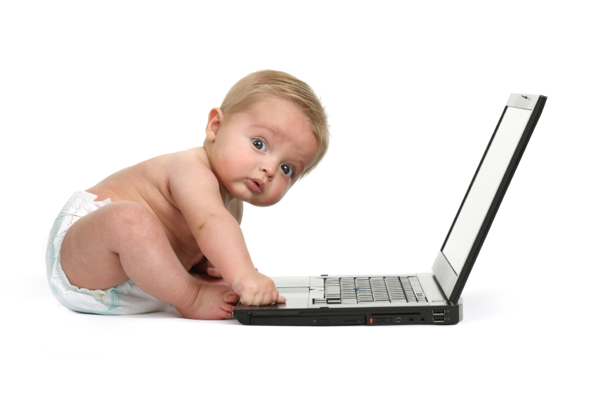 Surprised baby boy using a laptop computer