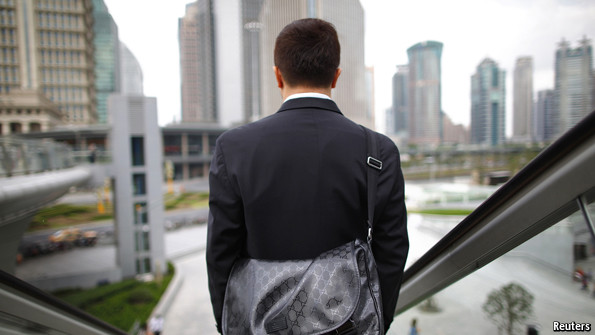 Man wearing suit on escalator